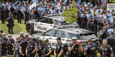 Toronto Police separate protestors from entering an Eritrean festival at Earlscourt Park in Toronto, Aug. 5, 2023